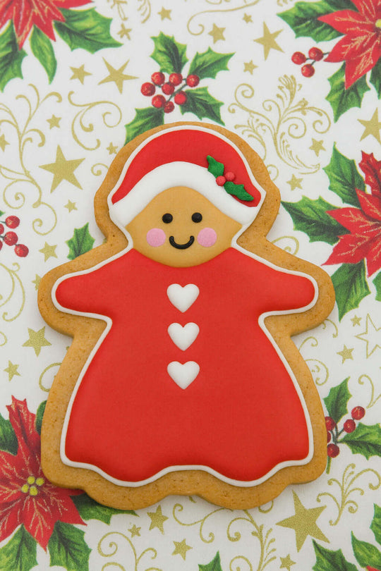 5 inch Gingerbread Girl Metal Cookie Cutter with red dress and festive decorations on a holiday background.