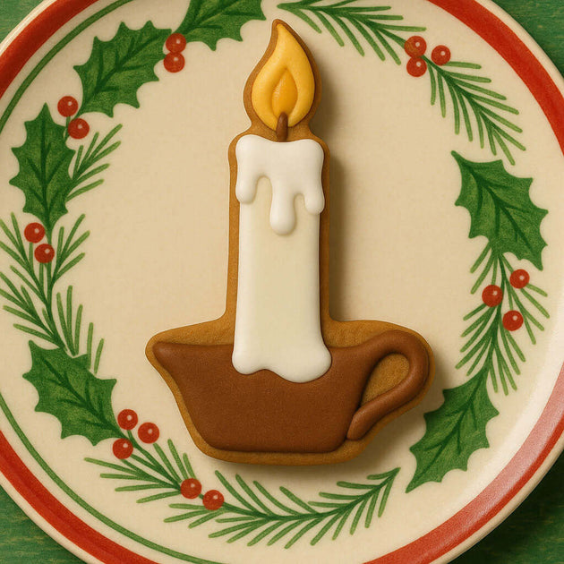 4 inch Candle Metal Cookie Cutter shaped cookie on a festive plate with holly and pine decoration.