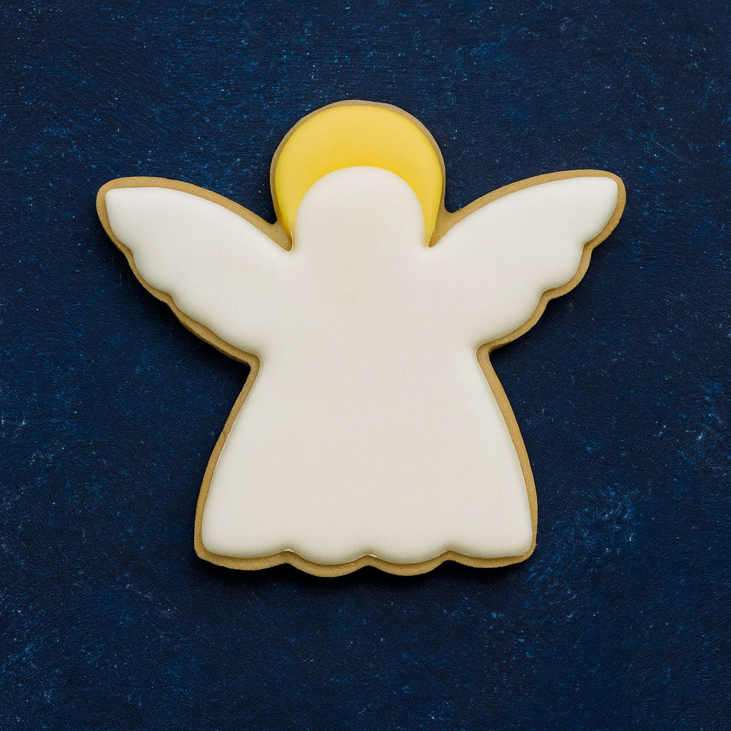 Angel-shaped cookie with white body and wings on a dark blue background from a 3 inch Angel Metal Cookie Cutter