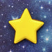 Yellow star-shaped cookie on a blue starry background from a 2 inch Mini Star Metal Cookie Cutter