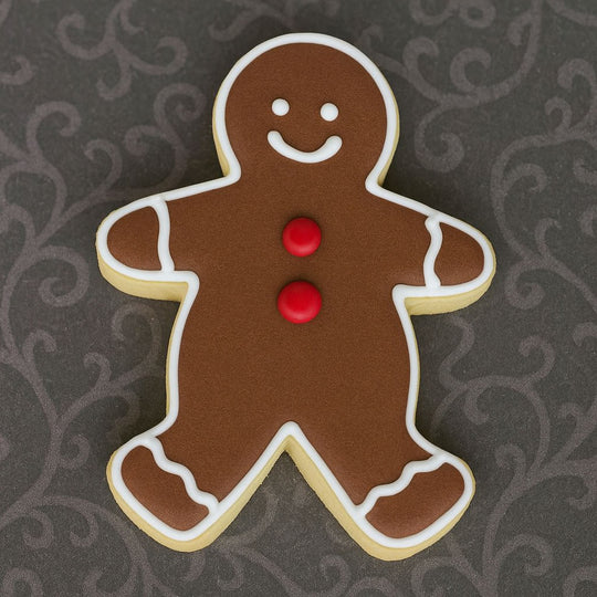 Gingerbread man cookie with red buttons on a dark patterned background from a 5 inch Gingerbread Boy Metal Cookie Cutter