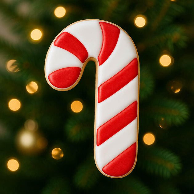 3.5 inch Candy Cane Metal Cookie Cutter displayed with colorful icing on a festive background of Christmas lights.