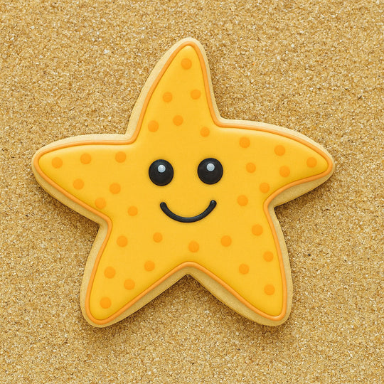 Star-shaped cookie with a smiley face on a sandy background from a 3.25 inch Folk Star or Starfish Metal Cookie Cutter