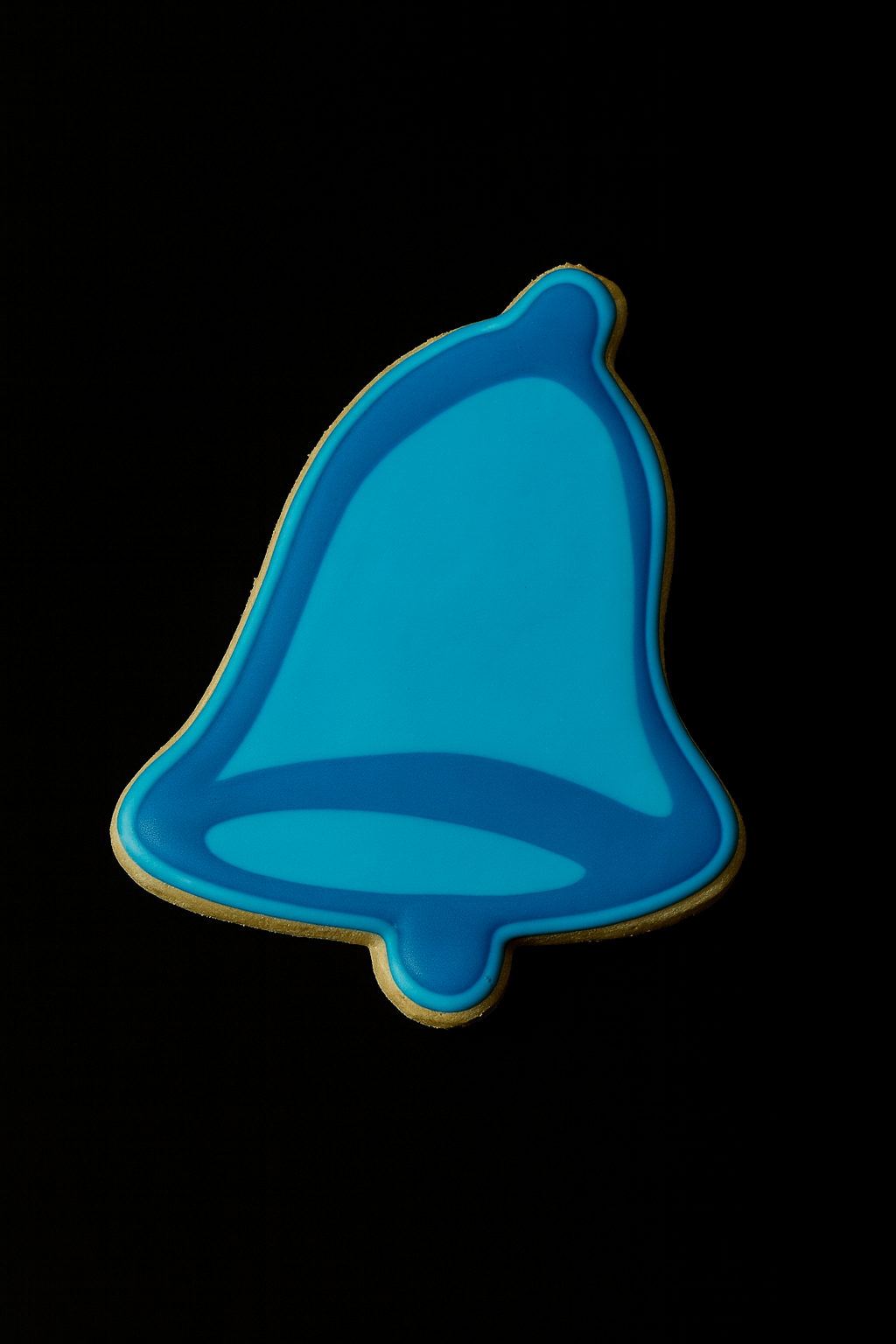 3.25 inch Folk Bell Metal Cookie Cutter in the shape of a blue bell-shaped cookie on a black background.
