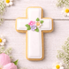 4 inch Cross Metal Cookie Cutter shaped cookie decorated with flowers on a rustic wooden background.
