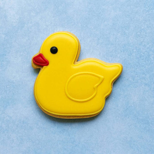 Yellow rubber duck cookie on a light blue background from a 2.5 inch Duckling Metal Cookie Cutter