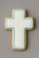 2.75 inch Cross Metal Cookie Cutter shaped cookie with blue icing against a gray background.
