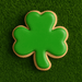 3 inch Shamrock Metal Cookie Cutter shaped green cookie on a grass background for St. Patrick's Day.