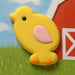 Yellow chick cookie on a colorful farm-themed background