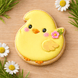 3 inch Easter Baby Chick Metal Cookie Cutter shaped cookie decorated with yellow icing and flowers.