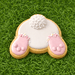 Decorative cookie shaped like a rabbit with pink feet and white fur on a green grass background for a 4 inch Easter Bunny Rabbit Butt Metal Cookie Cutter