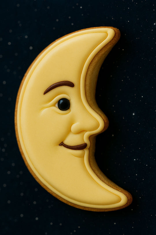 Cookie shaped like a crescent moon with a face on a dark background