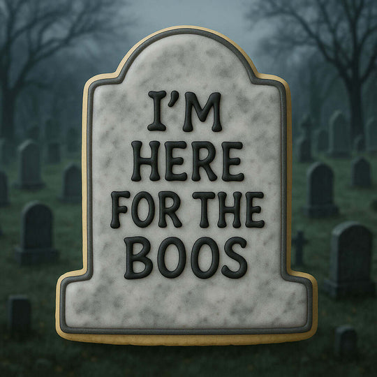 Halloween-themed tombstone cookie with 'I'm here for the boos' text against a cemetery background.