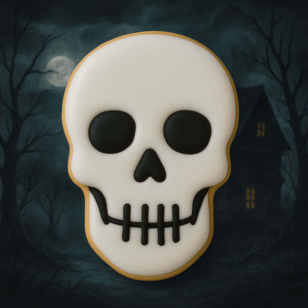 Skull-shaped cookie with a dark background featuring a moon and trees from a 3 inch Skull Metal Cookie Cutter