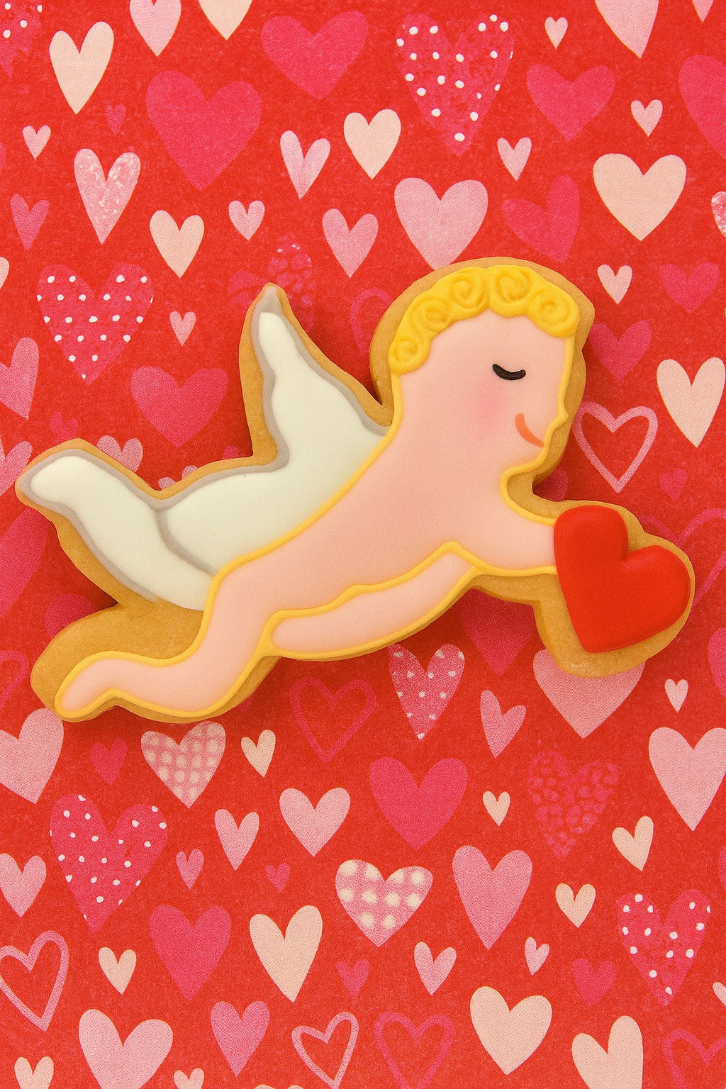 Valentine's Day cookie with angel design on a heart-patterned background from  4 inch Cupid Metal Cookie Cutter