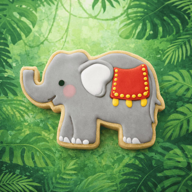 Decorative elephant cookie with a red blanket on a green leafy background from a 3 inch Elephant Metal Cookie Cutter