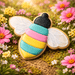 Colorful bee-shaped cookie on a grassy field with flowers from a 3 inch Bee Metal Cookie Cutter