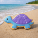 Tortoise-shaped cookie on a sandy beach with ocean in the background from a 4.75 inch Turtle Metal Cookie Cutter