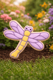 Decorative dragonfly shaped like a cookie on grass with flowers in the background from a 3.5 inch Dragonfly Metal Cookie Cutter