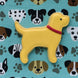 Yellow lab-shaped cookie with a red collar on a blue background with dog illustrations.