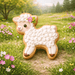 Sheep-shaped cookie with white frosting and brown feet on a grassy field with flowers from a 3.25 inch Standing Lamb Metal Cookie Cutter