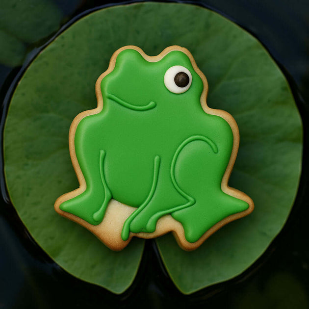 Green frog-shaped cookie on a green leaf from a 3 inch Frog Metal Cookie Cutter