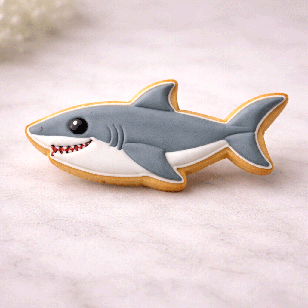 Shark-shaped cookie on a light background from a 4 inch Shark Metal Cookie Cutter