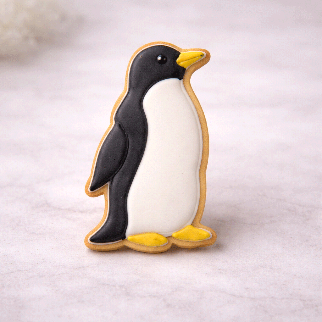 Penguin-shaped cookie on a light gray background from a 3.25 inch Penguin Metal Cookie Cutter