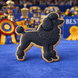 Decorative black poodle cookie on a blue surface with award ribbons in the background from a 4 inch Poodle Metal Cookie Cutter