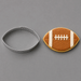 A football-shaped metal cookie cutter shown next to a decorated football-shaped sugar cookie on a smooth gray background from a 3.5 inch Football Metal Cookie Cutter