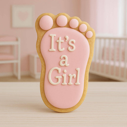 Cookie shaped like a foot with 'It's a Girl' text on a pink background from a 3.5 inch Right Foot Metal Cookie Cutter