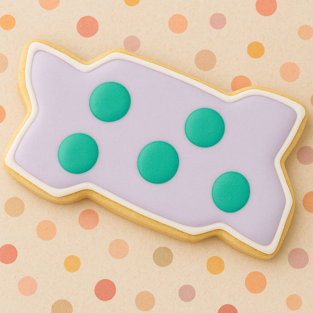 Cookie  with purple icing and green dots on a polka dot background 4 inch Zig-Zag Interlocking Brick Metal Cookie Cutter