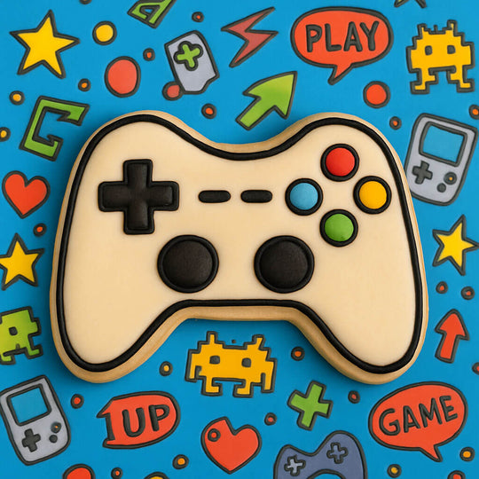 Cookie in the shape of a gaming controller on a colorful background with game-themed decorations.
