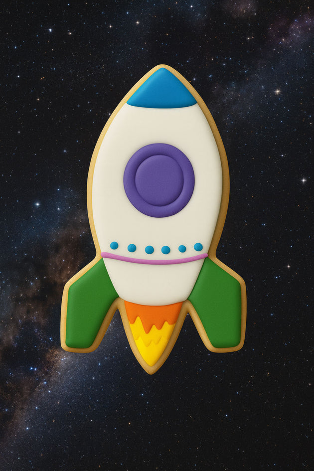 Decorative cookie shaped like a rocket ship on a starry space background from a 4" Rocket Ship Metal Cookie Cutter