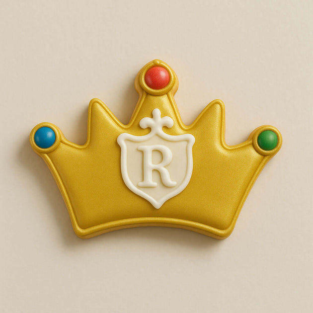 Decorative cookie shaped like a crown with a letter 'R' on a beige background from a5 inch Crown Metal Cookie Cutter