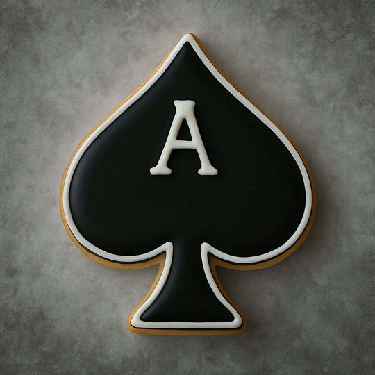 Cookie shaped like a spade with a white 'A' on a gray background