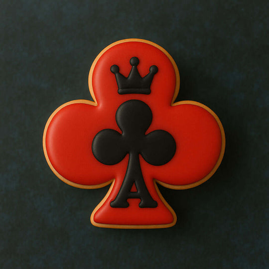 Cookie with a red clover design and black king of clubs symbol on a dark background