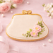 Decorative cookie shaped like a handbag with floral design on a pink background from a 4 inch Purse Metal Cookie Cutter