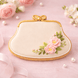 Decorative cookie shaped like a handbag with floral design on a pink background from a 4 inch Purse Metal Cookie Cutter