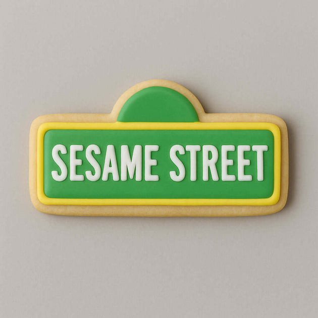Cookie shaped like a Sesame Street sign with green background and white text on a gray background from a 5 inch Street Sign Metal Cookie Cutter