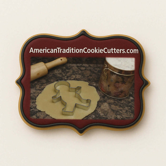 Cookie cutter with dough on a marble surface, branded 'American Tradition Cookie Cutters'.