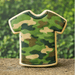 Camouflage t shirt shaped sugar cookie made with a 4 inch T Shirt Metal Cookie Cutter on a natural outdoor background