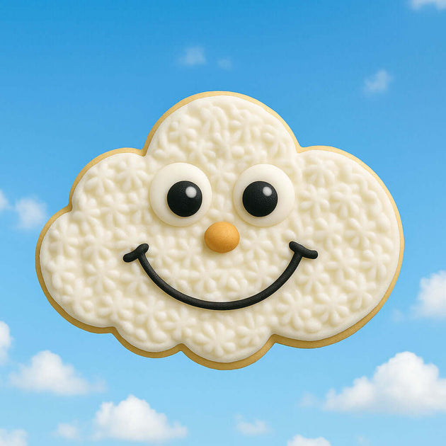 4 inch Cloud Metal Cookie Cutter shape cookie, smiling face, with a cloud design against a blue sky background.