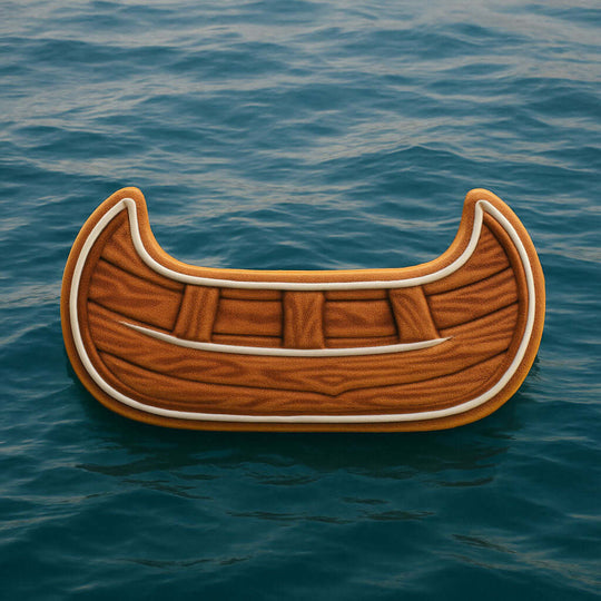 Wooden canoe-shaped object floating on blue water from a 4.5 inch Canoe Metal Cookie Cutter