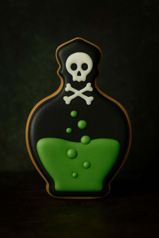 Cookie shaped like a poison bottle with a skull and crossbones on a dark background