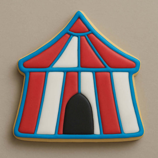 Cookie shaped like a circus tent with red, white, and blue icing on a beige background