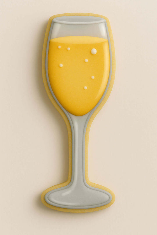 Decorative cookie shaped like a champagne glass with yellow filling on a beige background from a 5.25 inch Champagne Glass Metal Cookie Cutter
