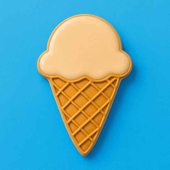 Ice cream cone-shaped cookie on a blue background from a 4 inch Ice Cream Cone Metal Cookie Cutter