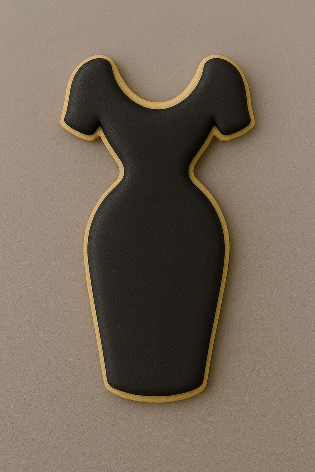 Black dress-shaped cookie with gold trim on a brown background from a 4 inch Dress Metal Cookie Cutter