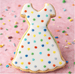 Cookie shaped like a dress with colorful polka dots on a pink background from a 4 inch Dress Metal Cookie Cutter